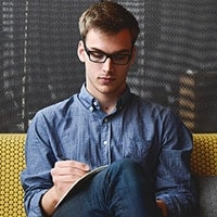 Man sitting and writing.